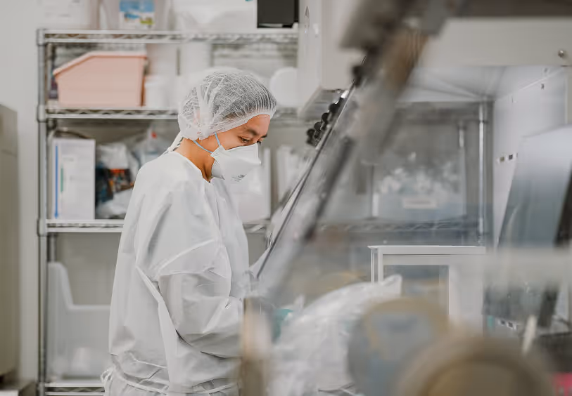 Technician working in a sterile compounding cleanroom.